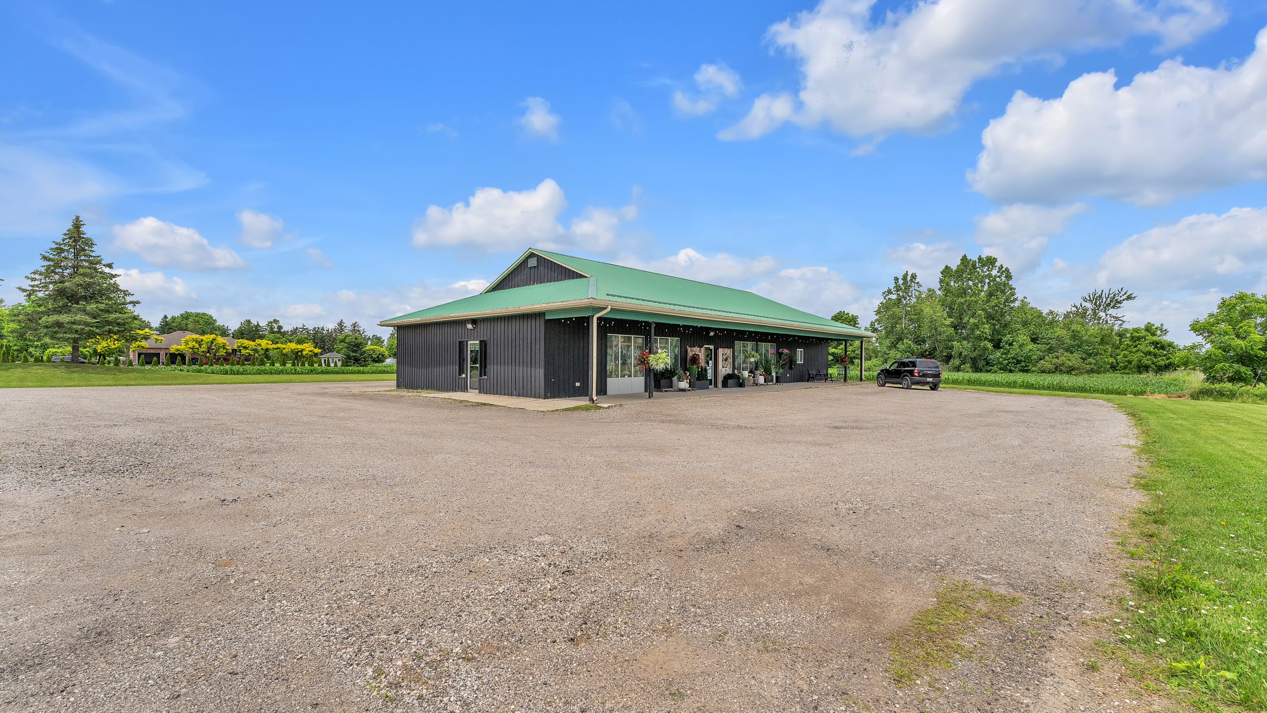 Parking lot and yard at 3014 Westminster Drive with the commercial building behind, London Ontario