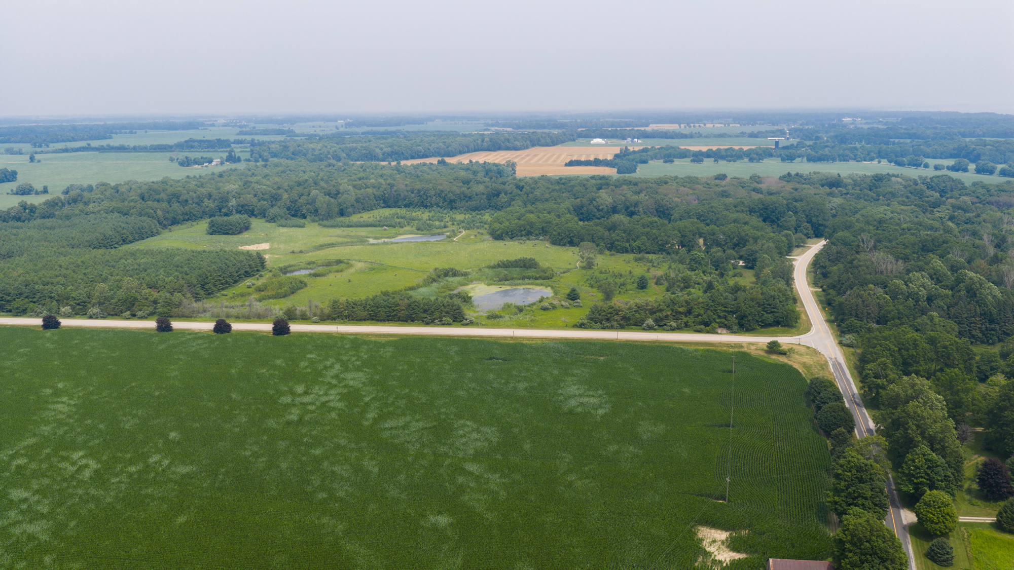 Aerial drone view of the rural acreage and countryside along Lakeview Line near John E. Pearce Provincial Park, Elgin County